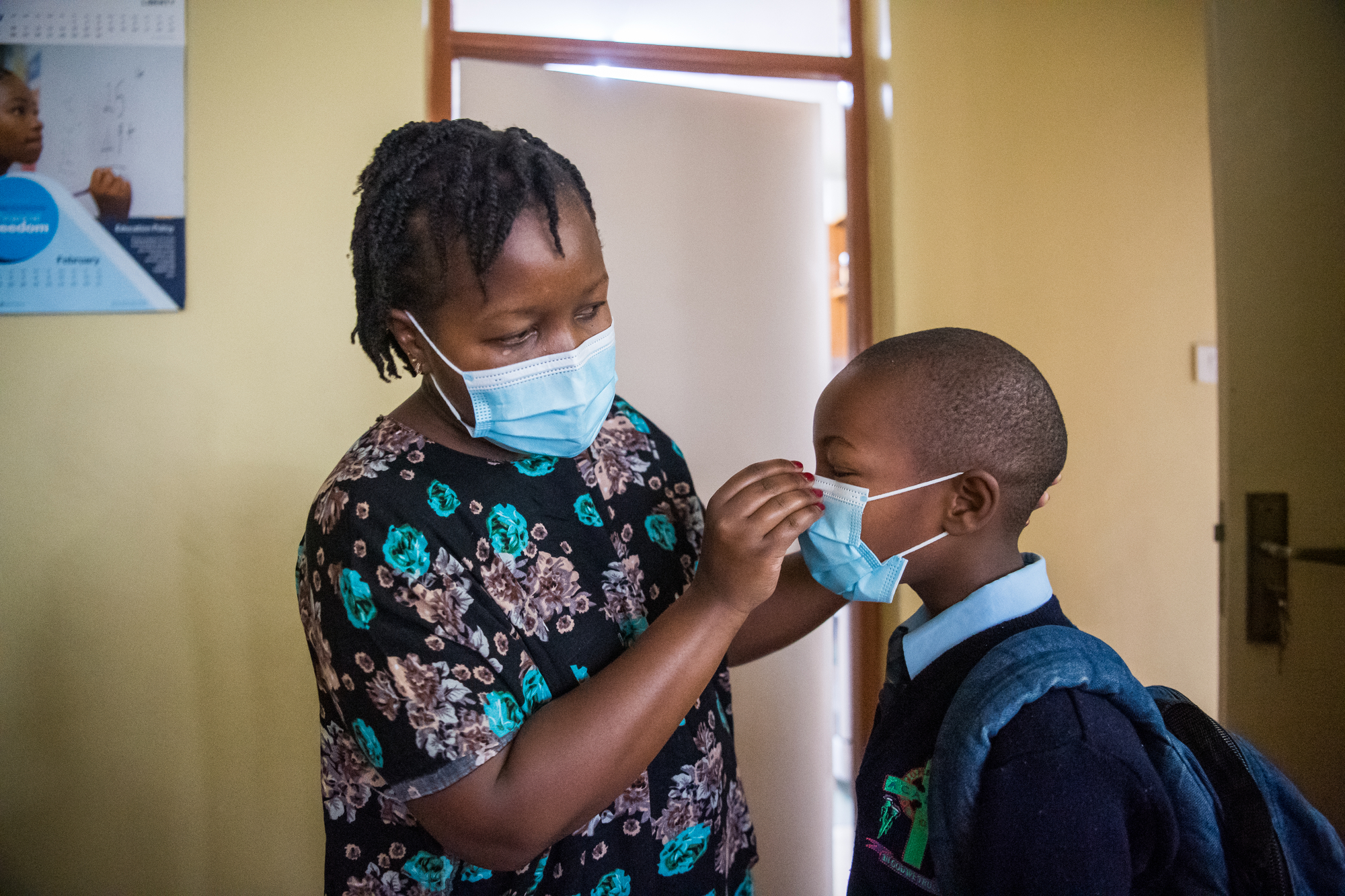  Janet Memo helps her children put masks on before leaving their small apartment in Nairobi, Kenya on February 22, 2021. The COVID-19 pandemic has challenged many women to balance working from home and caring for their children. 