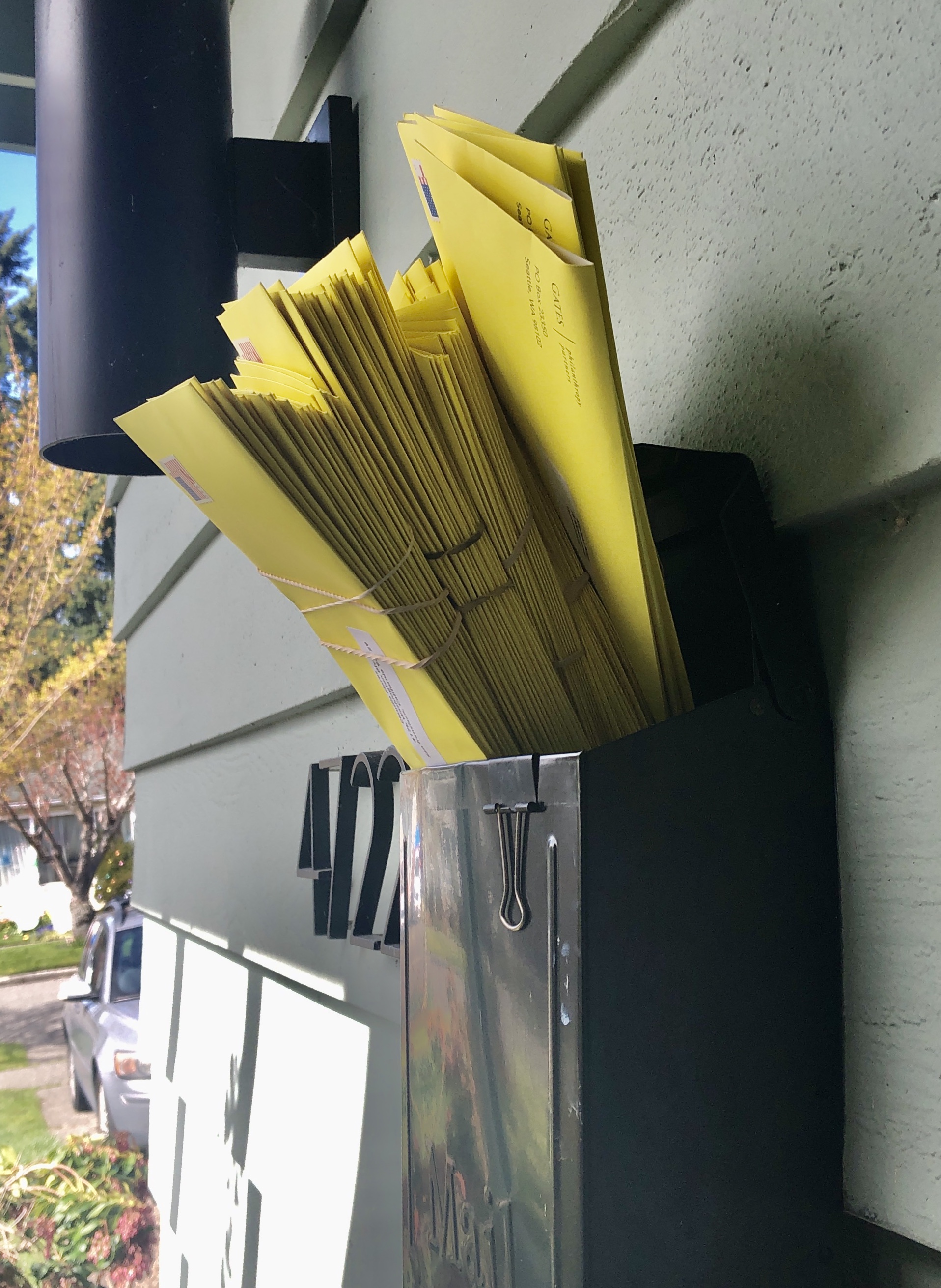 A stack of letters protruding out of a mailbox