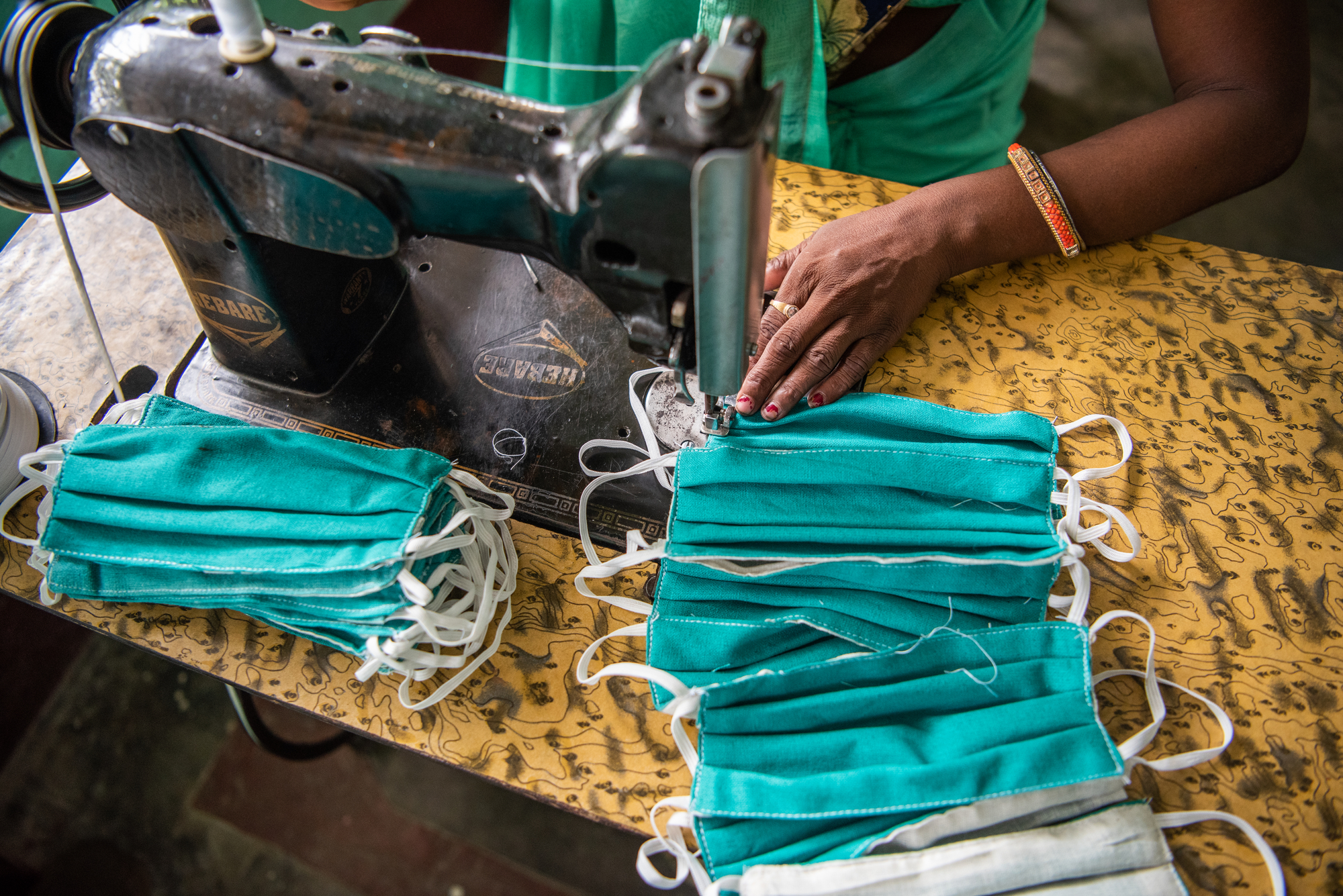 'JEEViKA Didis' (members of the self help group organized by JEEViKA) stitch masks at the mask production center in Daulatpur Deoria, Bihar, India on August 27, 2021. 'JEEViKA Didis' were instrumental in spreading awareness about COVID-19 vaccines at the peak of the pandemic. 