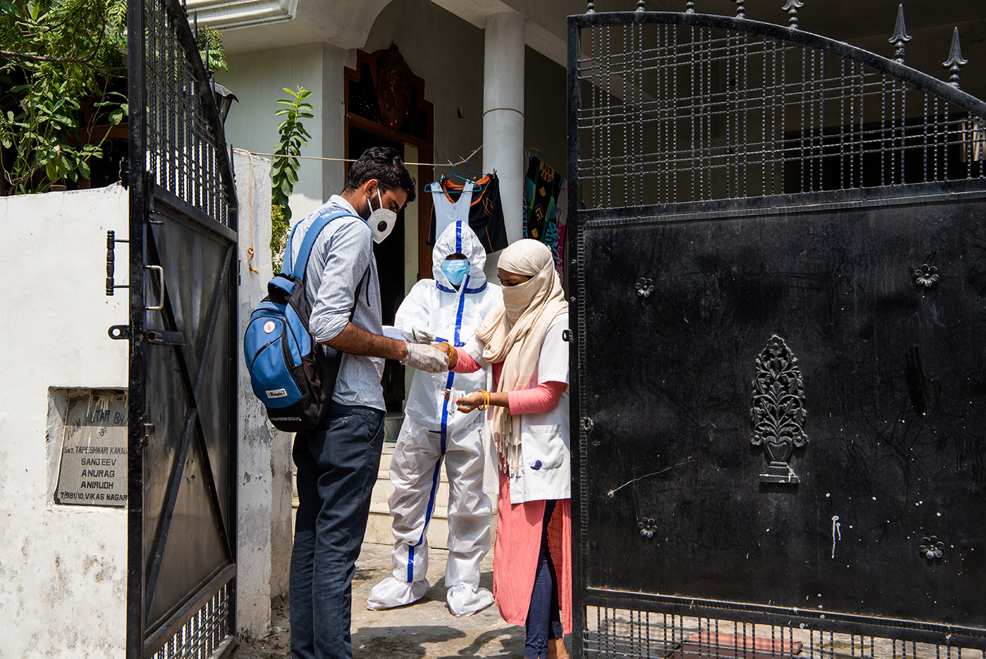 A sampling team collects swab samples at a location with COVID-19 positive cases, and is visited by a surveillance team in Puraniya slum in Lucknow, Uttar Pradesh, India on September 18, 2020.