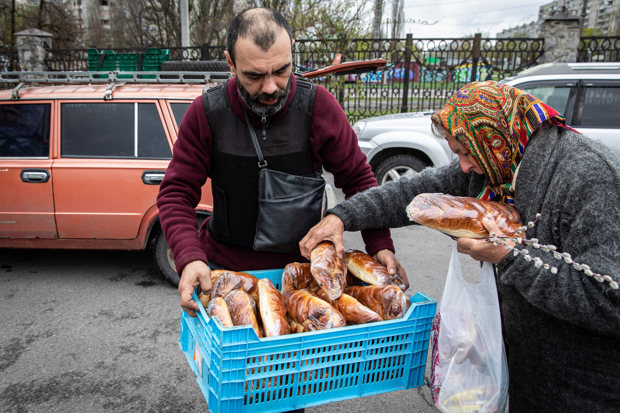 KHARKIV, UKRAINE - A volunteer distributes bread for the elderly in the northeast of Kharkiv, Ukraine.
