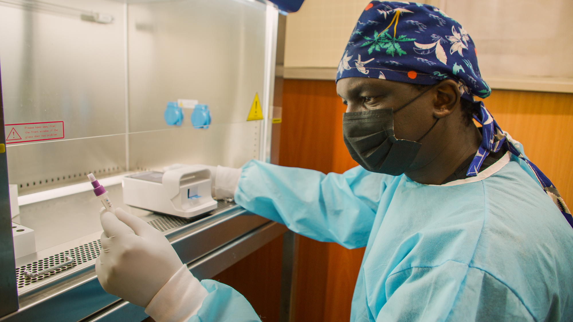 Dr. Onyimbo Kerama, Lead Consultant and Executive Director at Motire Occupational Safety and Health Solutions (MOSHS), uses the LumiraDx diagnostic instrument to test for COVID-19 in Thika, Kenya on August 31, 2021.