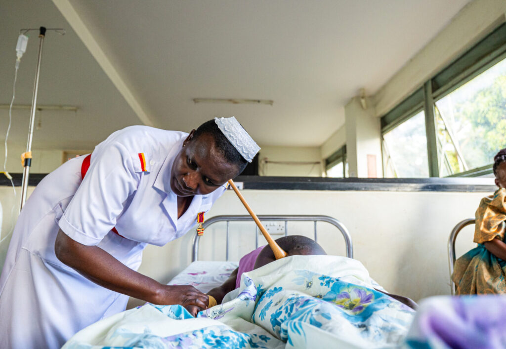 Midwife Eva Nangalo uses a Pinard horn to monitor the fetal heart rate during a prenatal visit for a pregnant patient in Nakaseke General Hospital's maternity wing in Nakaseke District, Uganda. September 7th,2023.